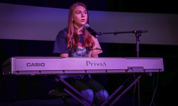 girl plays piano